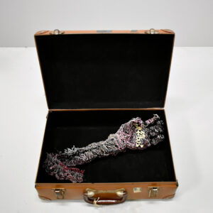 Desmond Mah, ‘My left hand operates at 25% capacity’, 2022, acrylic paint, mixed media, luggage, 12 x 36 x 24 cm. Image courtesy of the artist